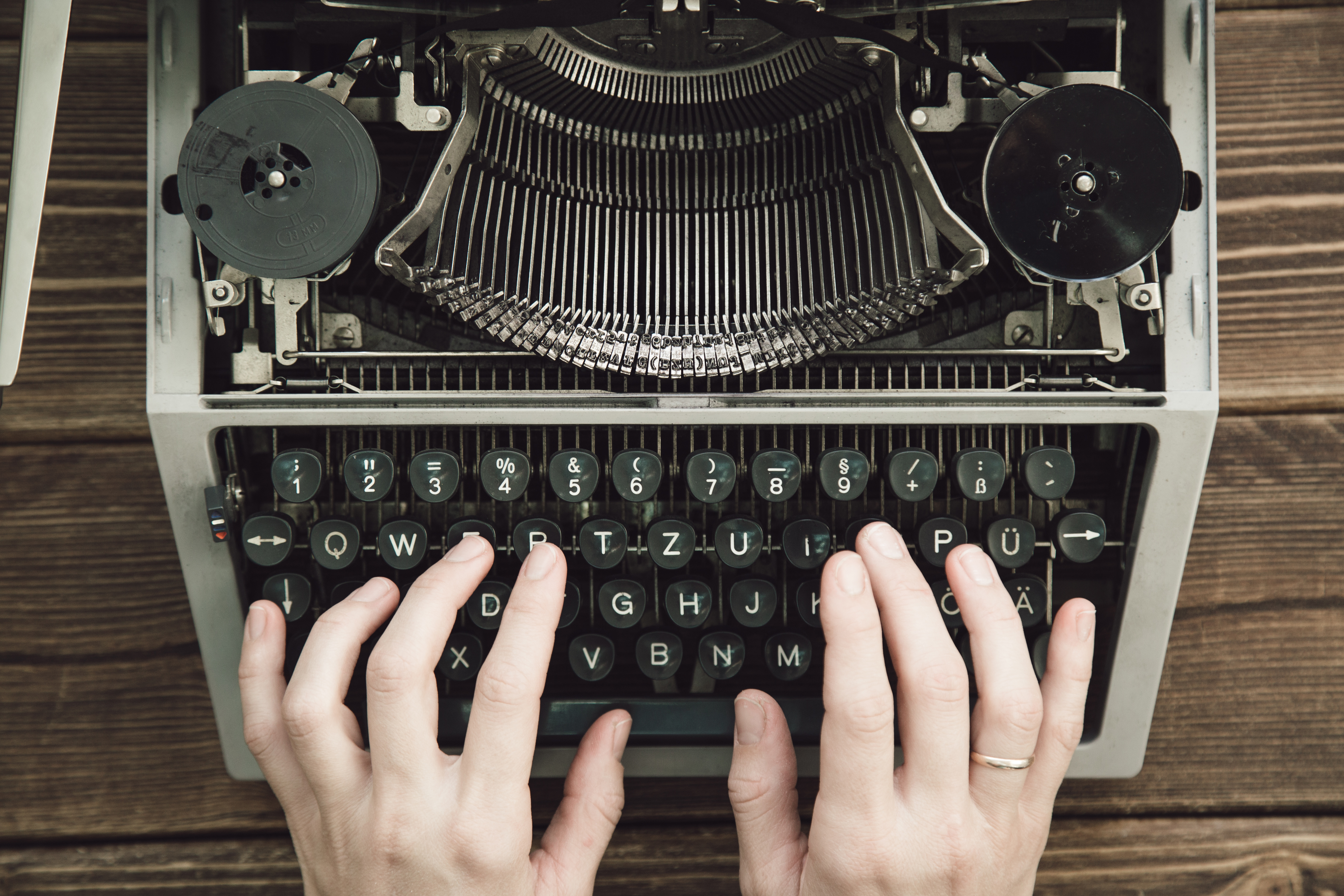 Hands typing on typewriter