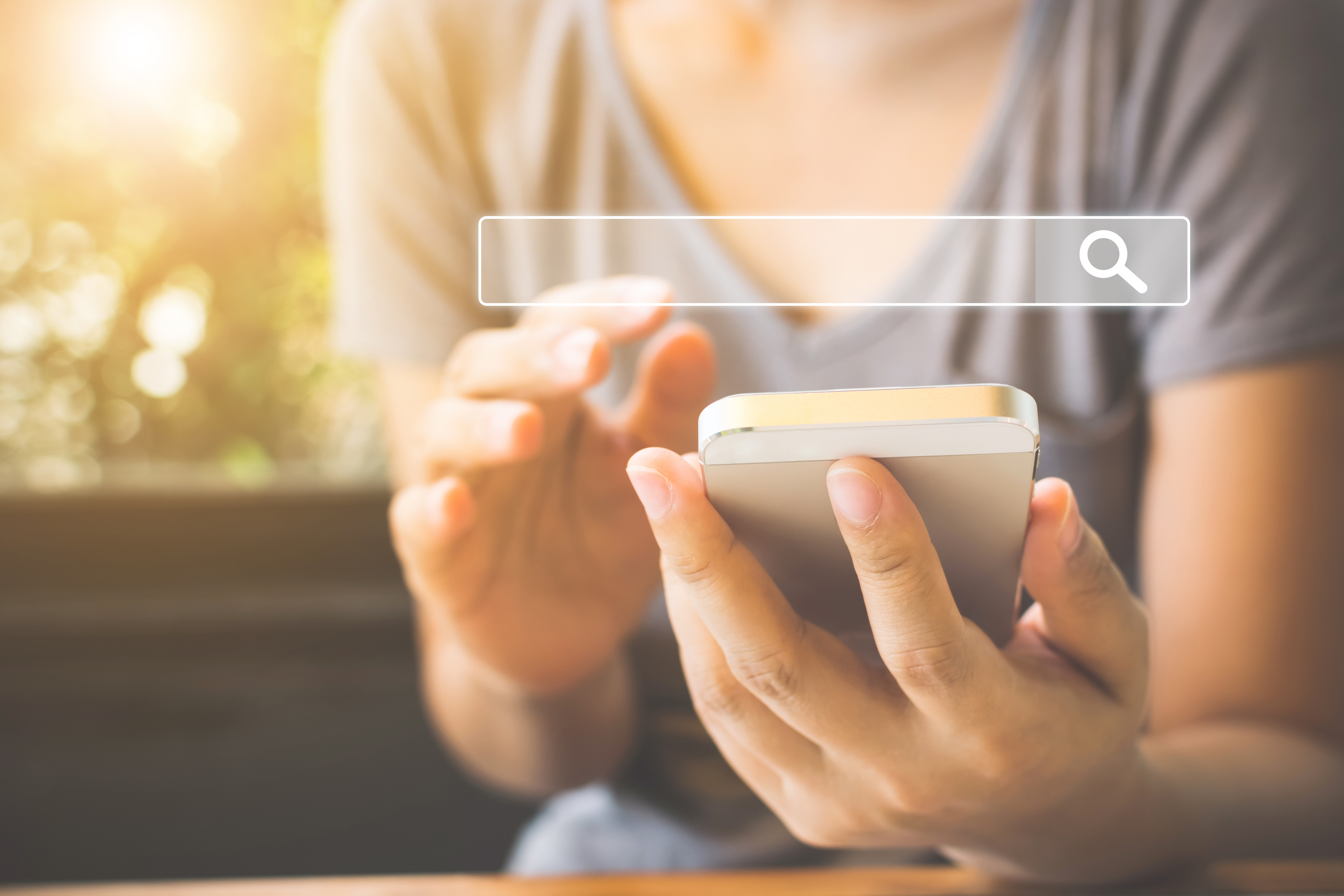 Stock image of woman searching on her iPhone