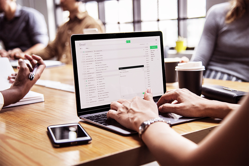 Person on their email inbox on their desktop at a desk