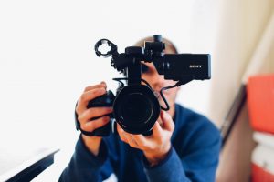 Man holding Sony video camera to camera 