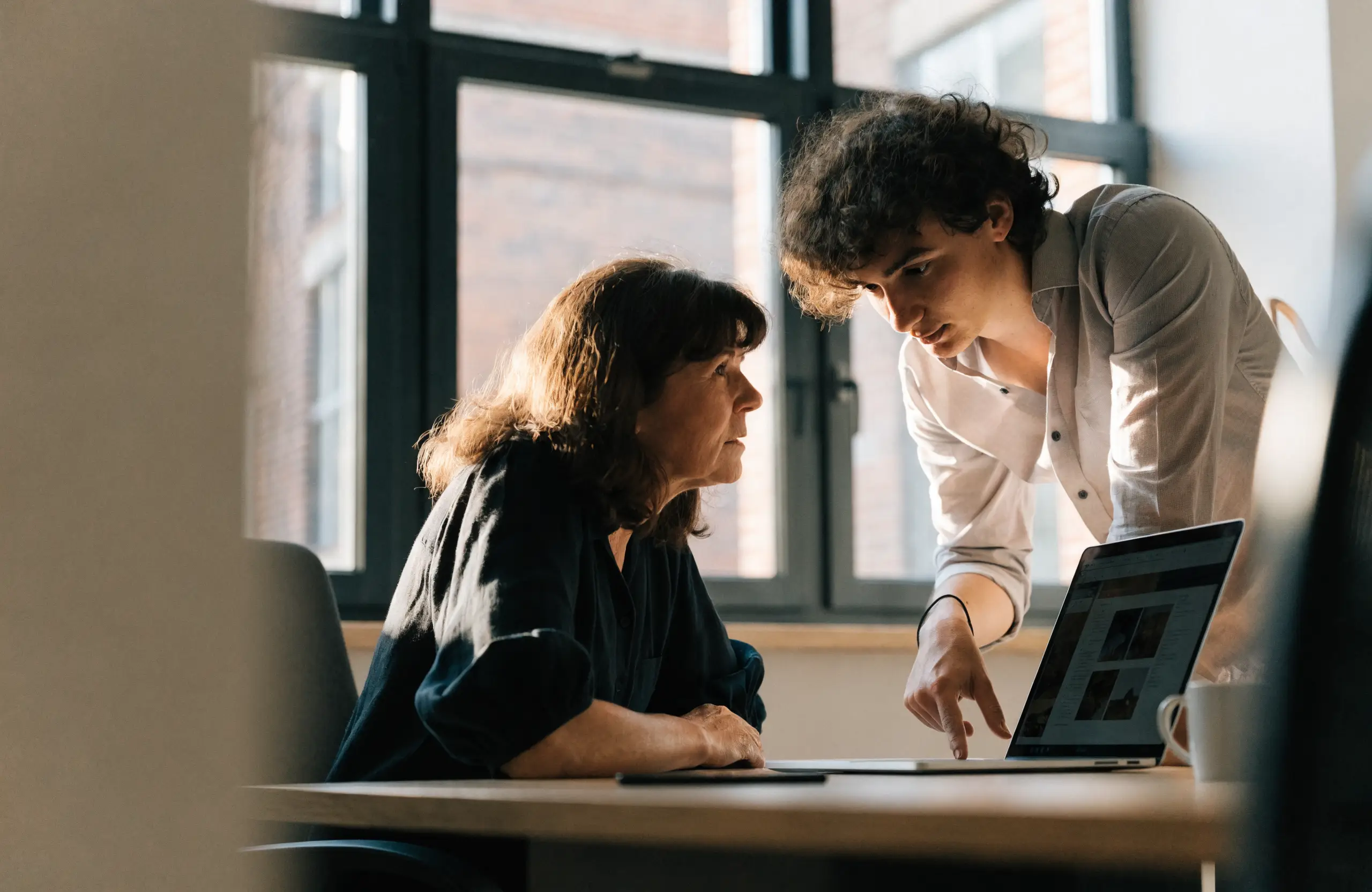 Web designer showing a website design to a small business owner