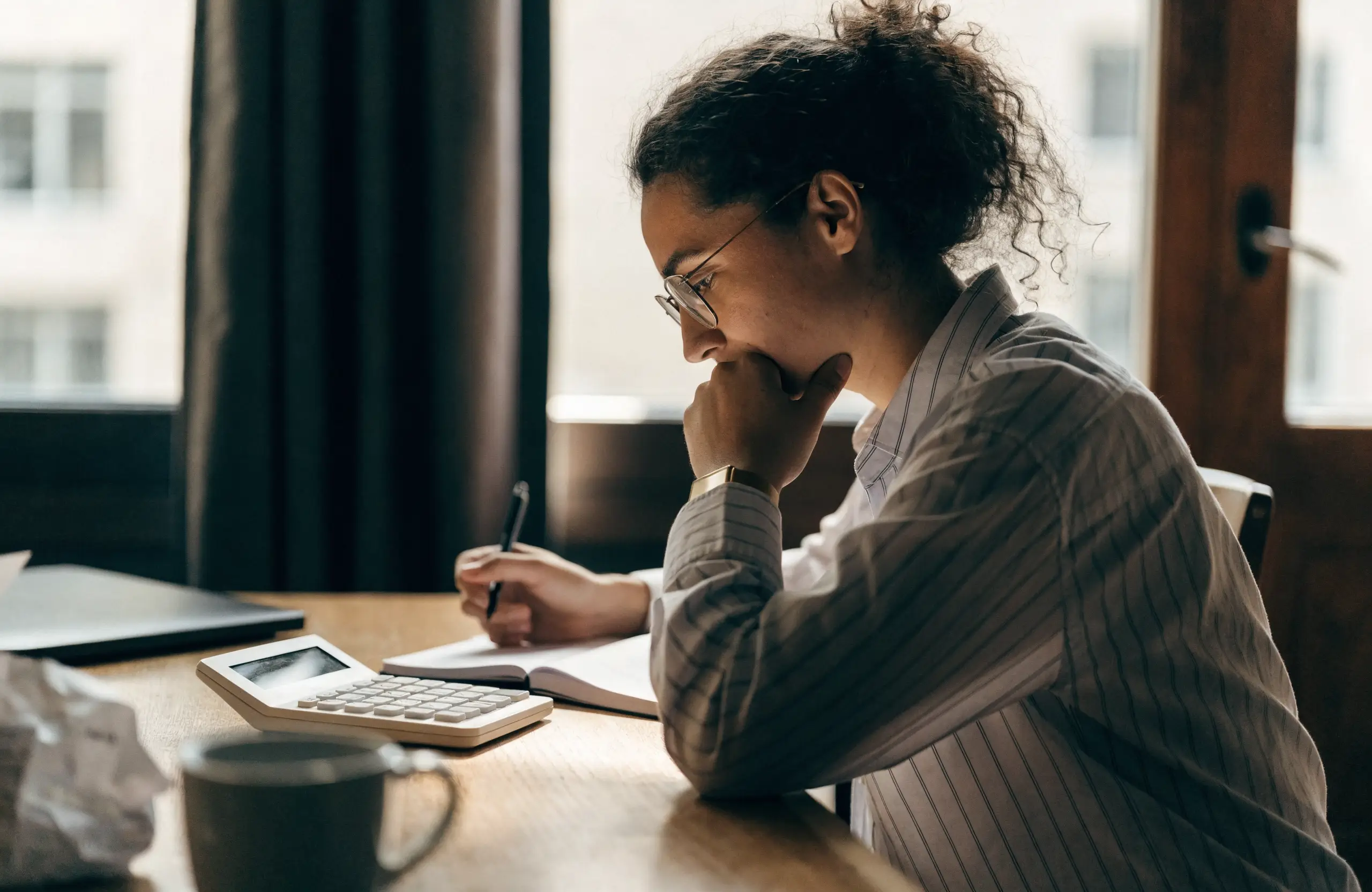 Small business owner planning a Facebook ads budget with a calculator