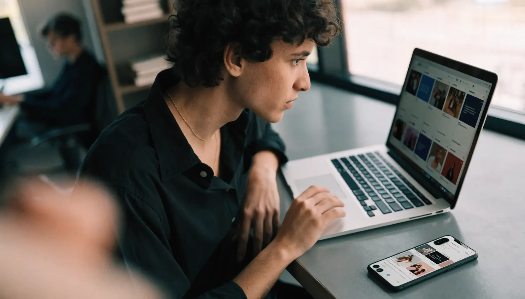 Marketer reviewing social media advertising performance on a laptop