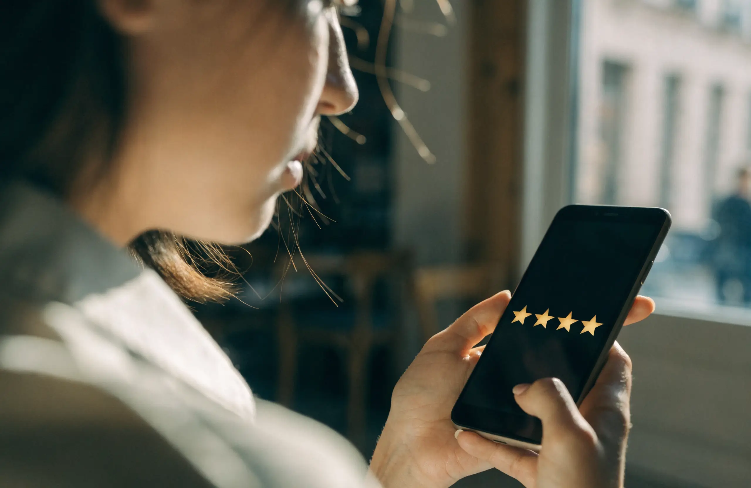 local-business-customer-review-smartphone - Caffeinate Digital Customer leaving a star review for a local business on a smartphone