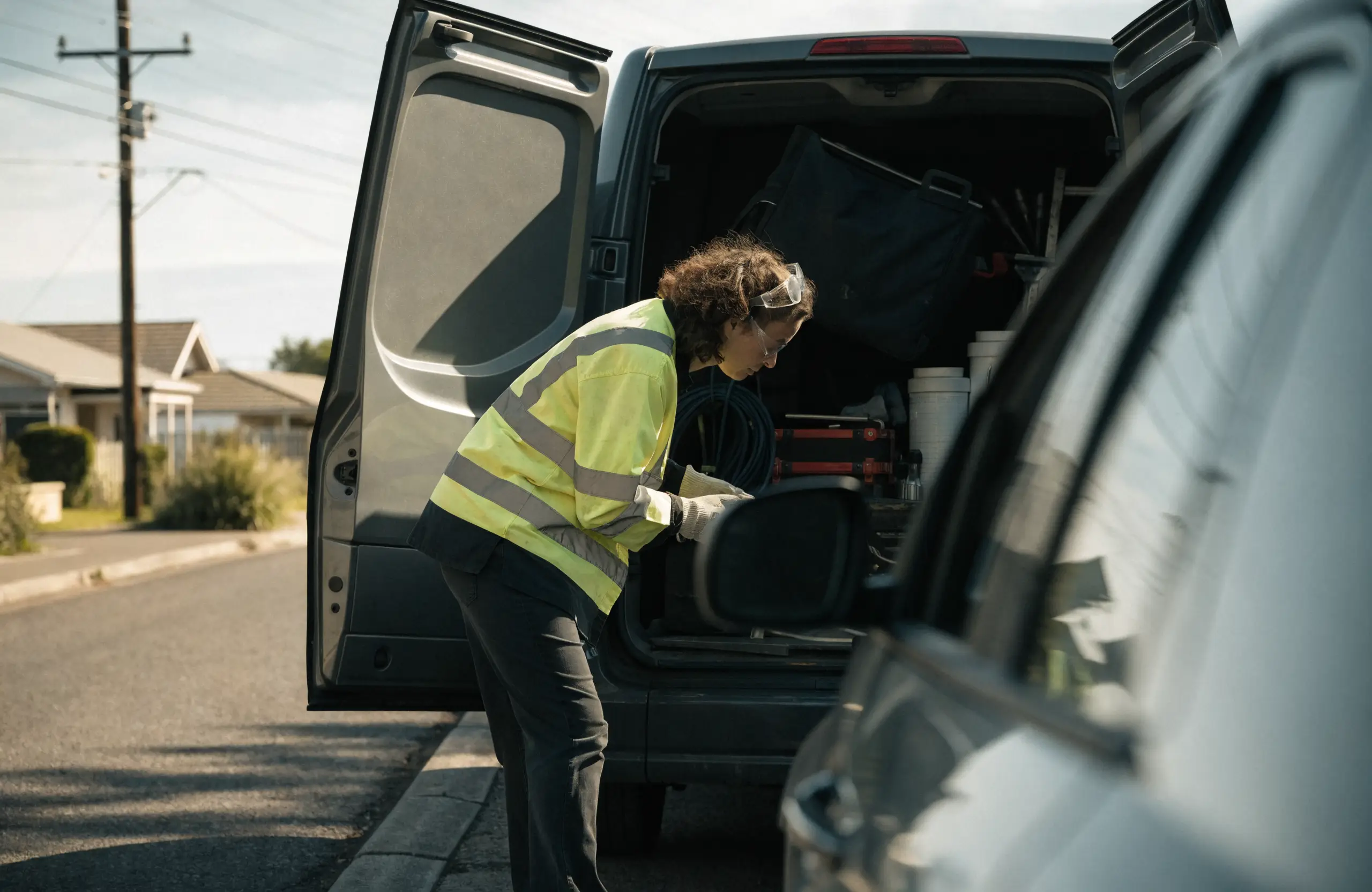 perth-tradesperson-electrician-van - Caffeinate Digital Perth electrician loading tools into her work van in a suburban street