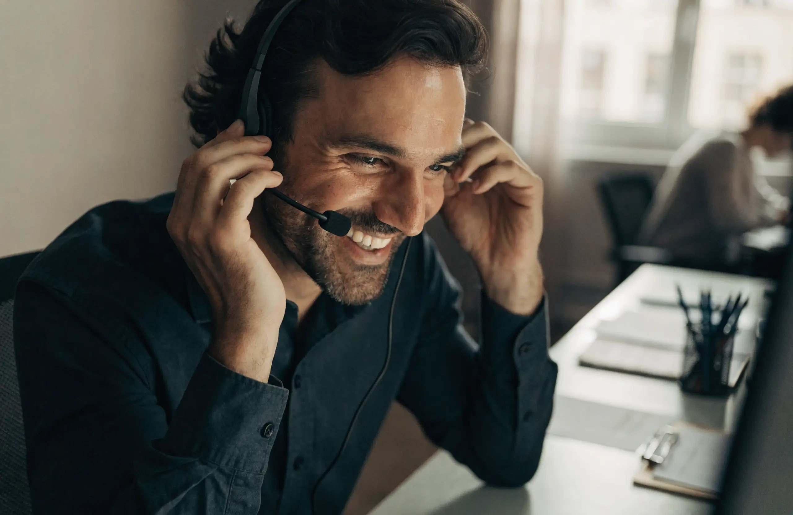 customer-conversation-headset - Caffeinate Digital Business owner having a warm phone conversation with a customer