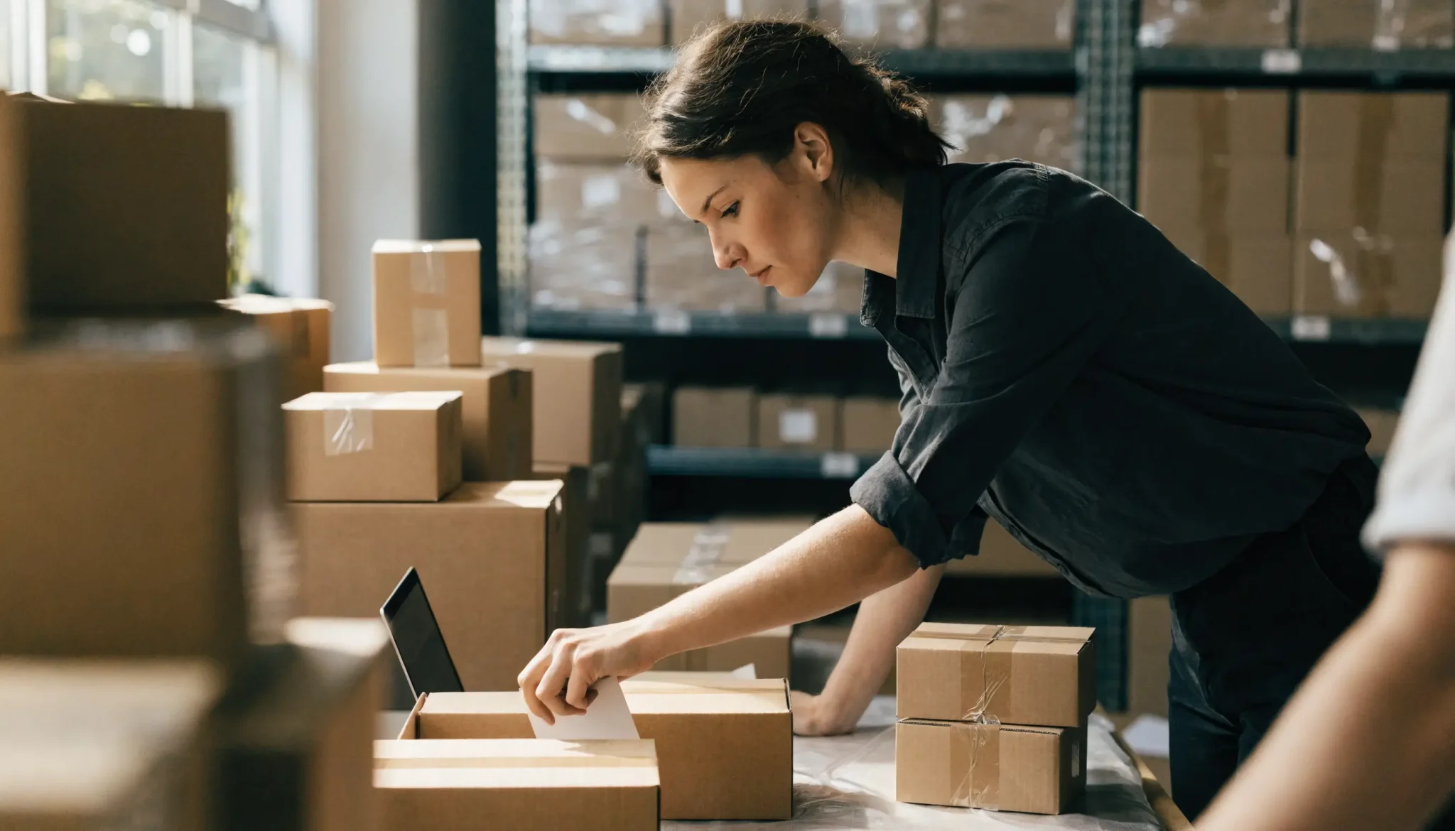 ecommerce-seo-online-store-packing - Caffeinate Digital Online store owner packing customer orders in a fulfilment warehouse