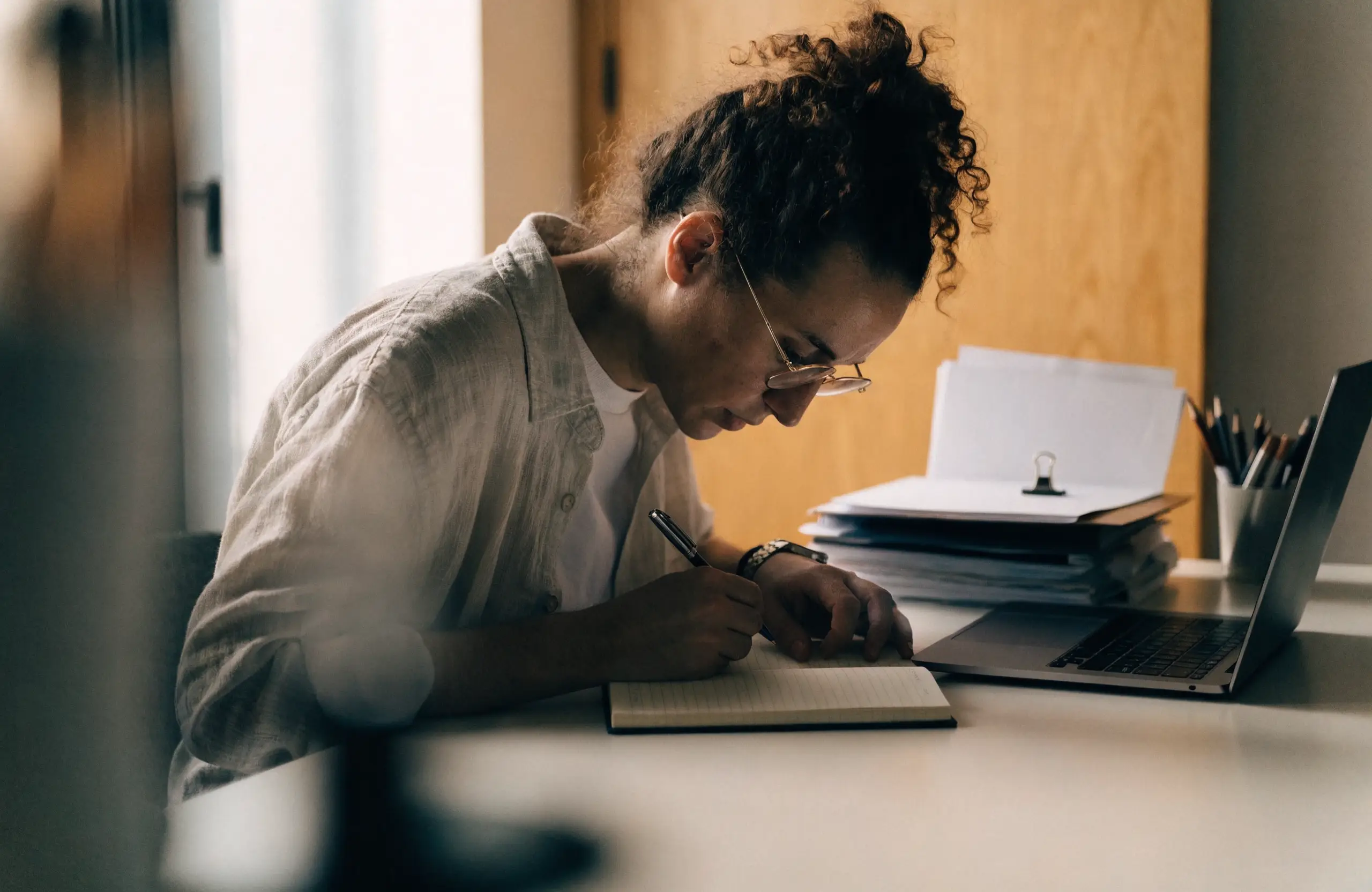 marketing-automation-planning-notebook - Caffeinate Digital Small business owner planning their first automations in a notebook